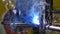Metal iron laser argon welding robot in factory slow motion.
