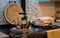 A metal kettle heating and towels drying on an old kitchen stove in the evening