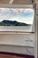 Metal ladder rungs on cruise ship deck with view of mountain scenery in background ner Ketchikan, Alaska.