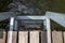 A metal ladder at a wooden pier. Descent to the water at the lake