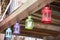 Metal lanterns suspended on wooden panel