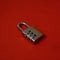 Metal lock with combination number isolated in red background