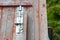 Metal lock on a wooden water well in the garden. Old brown well