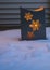 Metal luminary with snowflakes glowing