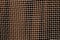 Metal mesh grid pattern in brown tone.