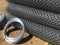 Metal mesh netting rolled into rolls and coils of steel wire. Rolled chain-link fence