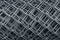 Metal mesh roll texture background. Gray metallic mesh cells in a roll.