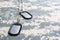 Metal military ID tags on camouflage background