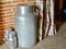 Metal milk cans in vintage house. Authentic details of old-fashioned spanish village