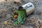 A metal mug with herbal tea turned upside down on the ground