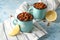 Metal mugs with fried chickpeas on table