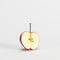 Metal nail screwed in half apple on white background