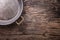 Metal old retro empty pan on oak kitchen table. Top view