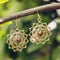 Metal oriental style earrings with mineral gemstone hanging on tree branch