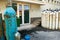 Metal oxygen tanks in front of the hospital doors. The door is marked with a sign with the inscription: