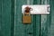 Metal padlock on wooden door