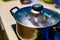 Metal pan with misted lid. Water droplets on the dishes during cooking on the electric stove. Close up. The view from