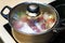 Metal pan with misted lid. Water droplets on the dishes during cooking on the electric stove. Close up. The view from the top