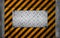 Metal panel on black yellow caution pattern