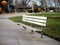 Metal park bench and picnic area in park.