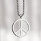 Metal peace symbol necklace medallion on a white