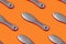 Metal pedicure tool on orange background. Beauty salon concept