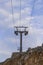 Metal pillars of the chairlift. Mountain slopes in summer