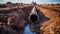 Metal pipe in trench, pipeline construction in ground, old underground water line and dirt. Concept of technology, oil, gas, work