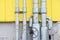 Metal pipes with manometers and valves on the yellow wall