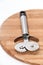 Metal pizza cutter on the round board