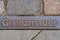 Metal plate on a walkway in Berlin indicating where the Berlin wall stood