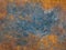 Metal plate with weathered colors and rust. Natural light. Blue and orange metal plate. Old oxidized colorful textured