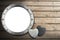 Metal Porthole on Wooden Boardwalk with Sand