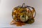 Metal pumpkin filled with fall decorations