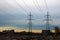 Metal pylons of power lines towering over the city