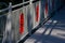 Metal railings of a pedestrian bridge with a bright red atom symbol