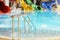 Metal railings, pool and multi-colored water slides