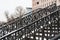 Metal railings and stone steps against the backdrop of tall houses covered with a thin layer of snow