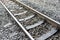 Metal railway tracks and sleepers with stone background