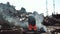 Metal recycling, worker cuts rusty metal with a gas cutter on a scrap metal