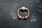 Metal ring on grave of cemetery. Rusty iron handle on granite tomb cover. An 19th century antique cemetery in Lvi