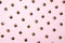 Metal rivets on pink glamourous background. Sample of stylish clothing products. Textured background. Fashionable rocker pattern