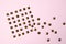 Metal rivets on pink glamourous background. Sample of stylish clothing products. Textured background. Fashionable rocker pattern