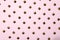 Metal rivets on pink glamourous background. Sample of stylish clothing products. Textured background. Fashionable rocker pattern