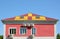Metal roofing construction. House with a mansard and skylight windows. Rain gutter and snow guard. A multi-colored metal roof