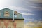 Metal roofing. Rain gutter on the roof top of house. Modern house with mansard windows against the blue sky. Chimney of building.