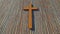 Metal rusted cross on a natural wood or wooden logg background. 3d illustration metaphor for God, Christ