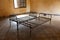 Metal rusty beds in empty prison room, Cambodia