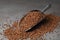 Metal scoop with uncooked buckwheat