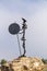 Metal sculpture of Don Quijote perched on a rock at the windmills of Mota del Cuervo